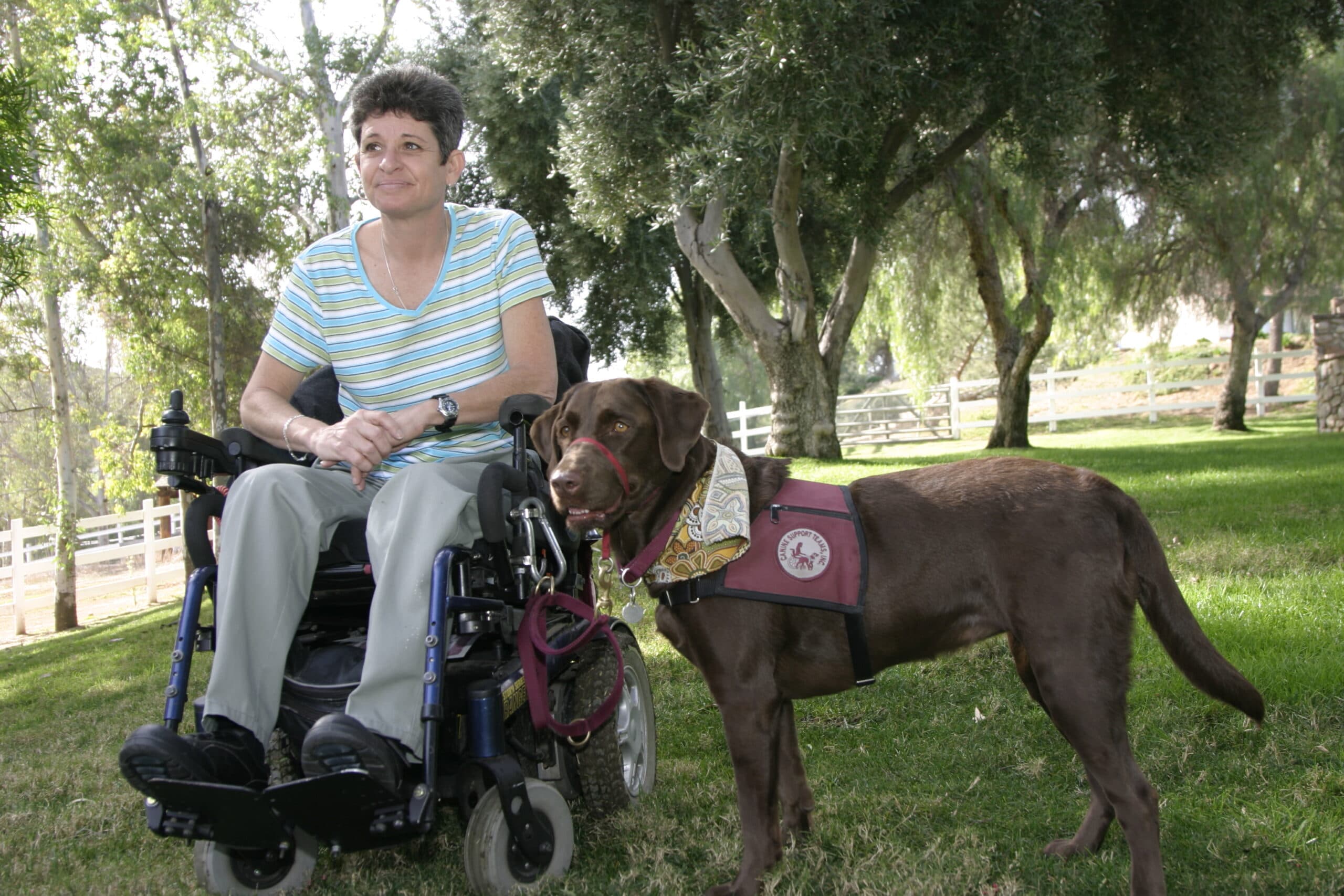 Canine Support Teams graduates with service dogs outdoors